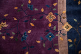 Close-up of vintage Nichols carpet showing plum field with delicate vinery and pale gold border.