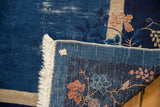 Vintage Peking carpet corner: indigo blue pile, delicate vinery, machine fringe, and exposed foundation.