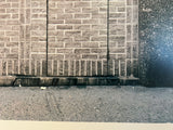 Gritty textural details of a geometric brick wall and sidewalk in the NYC photograph 