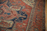 Antique Serapi carpet detail with madder red field, navy blue turtle samovar border, and palmette motifs.