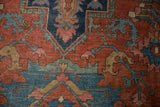 Detail of antique Serapi carpet: madder red field with dusty teal floral palmettes.