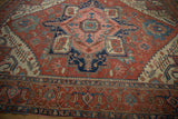 Madder root red and navy blue turtle samovar main border of an antique Serapi carpet.