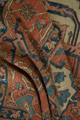 Antique Serapi carpet's madder root red field, blue palmettes, and sand turtle samovar border.