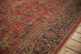 Worn madder root red floral field and charcoal Samovar border of the Mahal rug.