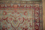 Distressed Yezd rug's delicate red floral border with arabesques and blue field.