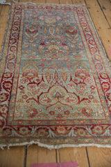 Tattered edge and worn red arabesque border of a vintage Yezd runner.