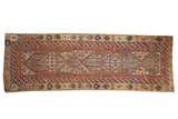 Antique Serab runner with a geometric double medallion and animal motifs in camel, red, and indigo blue tones.