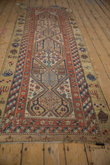Angled view of an antique Serab runner showing its full length and geometric medallion design.
