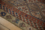 Stylized animal and boteh motifs on the camel-colored outer border of an antique Serab runner.