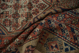 Folded antique Serab runner showing hand-knotted texture in camel, indigo, and madder red hues.