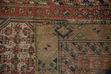 Close-up of the antique Serab's construction, showing the front pile and hand-knotted back weave.