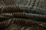 Textured pile of vintage Malayer rug with distressed beige, brown, and dusty blue patterns.