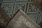 Vintage Malayer rug's distressed blue starbursts and beige hand-knotted foundation.