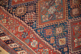 Geometric botehs and pinwheel designs show the intricate hand-knotted pile of an antique Afshar.