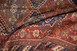 A folded view of an antique Afshar runner revealing its intricate tribal geometry and low pile.