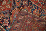Folded corner of an antique Afshar rug revealing its dense hand-knotted foundation and secured selvage.