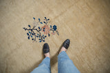 Soft, beige Peking carpet pile showcasing a cobalt blue and pink floral bouquet detail.