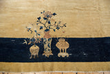 Vintage Chinese Peking carpet's pictorial border showing cobalt blue and rust vases and blossoms.