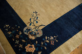Vintage Chinese Peking carpet with pictorial cobalt blue border and varied floral motifs.