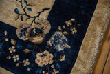 Worn cobalt blue floral border and exposed foundation of a vintage Peking carpet.