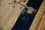 Vintage Peking carpet: beige field with blue blossoms, pictorial cobalt border showing wear.