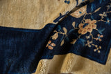 Soft wool pile texture of vintage Peking carpet, with cobalt blue border and floral blossoms.