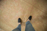Soft wool pile and muted rose and sand tones on the distressed vintage Oushak carpet.