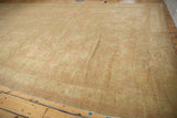Distressed beige Oushak rug pile with soft pink accents along the edge.