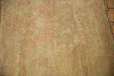 Distressed Oushak rug showing soft wool pile texture in beige and blush.
