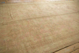 Soft wool pile and faded large-scale patterns on distressed vintage Oushak rug.