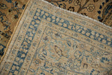 Detail of vintage Meshed carpet: sand and faded indigo palmette pattern, exposed knot heads, selvage.