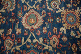 Curvilinear floral arabesque motif with sapphire blue, madder red, and mallard green tones on a Mahal rug.