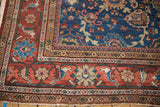 Vintage Mahal rug corner, intricate madder root red floral border on sapphire blue field.