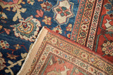 Close-up of vintage Mahal carpet corner, showing secured edge binding, fringe, and hand-knotted foundation.