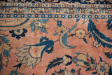 Hand-knotted Laristan carpet with dusty rose, navy, teal scrolled vines and geometric border.
