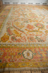 Vintage Oushak carpet border with blush, saffron yellow, and dusty teal palmettes.