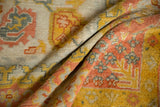Vintage Oushak carpet's textured pile, saffron yellow, blush, dusty teal palmettes.