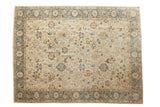 A vintage distressed Tabriz carpet with an allover floral design in ivory, dusty sky blue, and coffee brown.