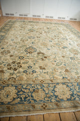 Angled view of a vintage distressed Tabriz carpet highlighting the allover floral pattern and soft colors.