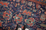 The texture of gem-toned floral and animal motifs on a low-pile vintage Persian Malayer rug.