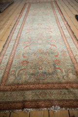 Distressed vintage Malayer runner showing faded Herati design with visible wear and foundation.