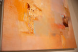Angled detail of abstract painting, highlighting impasto texture and layered orange, blue tones.
