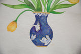 Close-up on the artist's initials next to the blue and gold vase in a watercolor tulip painting.