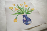 The Yellow Tulips original painting shown at an angle on textured, handmade paper.