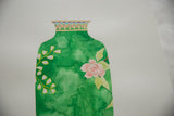 Ink-detailed neck and pink flower on a green watercolor vase painting.
