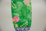 Close-up of the green watercolor wash and pink flowers on the painted antique vase.