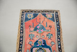 Lower right of Sarah Martinez painting: watercolor deckled edge, peachy-pink, and deep blue geometric motifs.