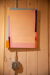 Abstract Colorblock No. 23 painting by Sarah Martinez displayed on a wood-paneled wall.
