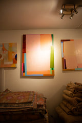 A gallery view of the Sarah Martinez Colorblock No. 13 painting with other art and vintage rugs.