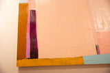 Textured close-up of acrylic paint in peach, magenta, and ochre on an abstract painting.